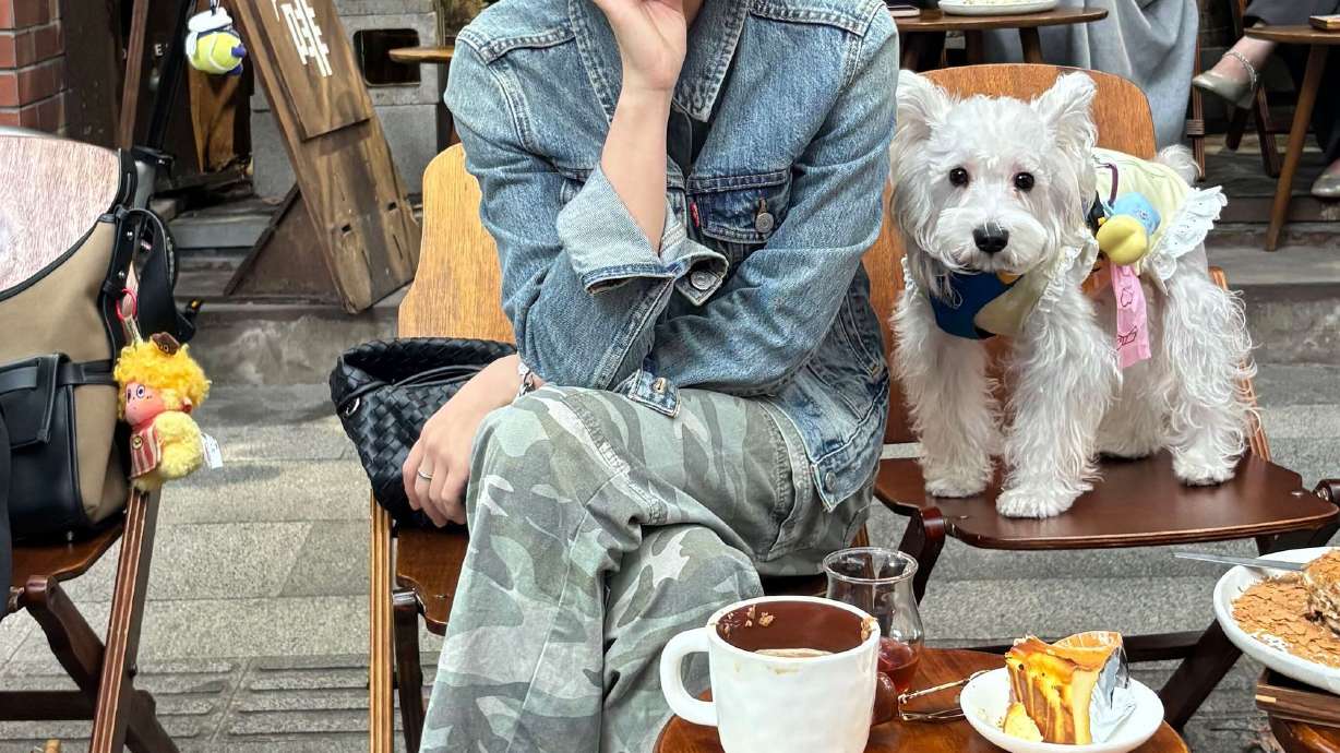 Ma Xue Li people watches from a cafe in the former French quarter. After having a coffee, she will shop the tranquil area's many boutiques.