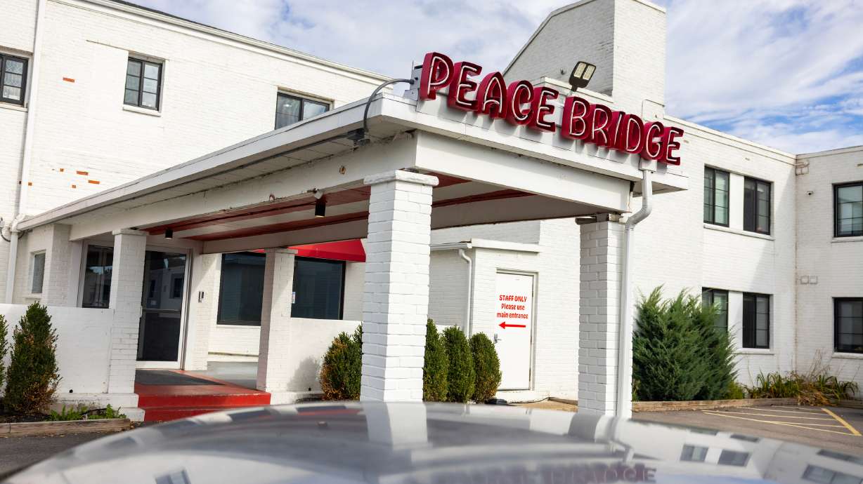 A sign is displayed for Peace Bridge Place apartments that have Viridi's lithium-ion battery energy storage system in Buffalo, N.Y., Thursday. A battery system installed in a Buffalo apartment building will store excess energy when it's plentiful and power the building when the grid is strained and electricity is costly.
