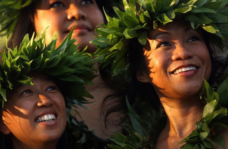 FILE PHOTO: Members of a hula dance group watch other dancers after performing with Pua Alii Ilima (The Royal Flowers) at the Waikiki Shell on Waikiki Beach in Honolulu, Hawaii, July 1, 2005.