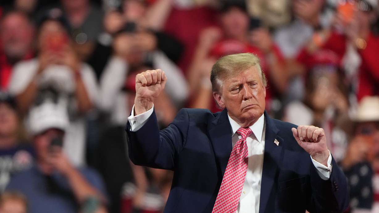 President Donald Trump does his signature dance at a campaign rally at Heartland Credit Union Arena, Monday, in Park City, Kan. Trump and Vice President JD Vance on Tuesday announced a program to encourage public fraud reporting.