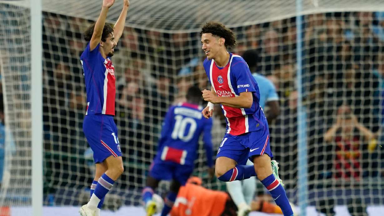 PSG's Maghnes Akliouche, center, celebrates after scoring his side's fourth goal during the Champions League opening phase soccer match between Manchester City and Paris Saint-Germain in Manchester, England, Wednesday, Oct. 14, 2026.