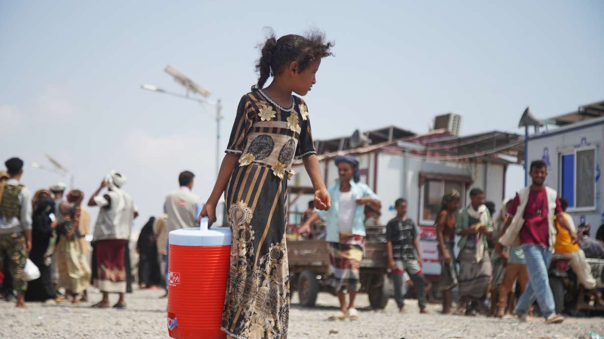 A displaced Yemeni girl walks at Al-Firdaws 2 camp in Ras Imran, on the western outskirts of Aden, Yemen, Tuesday. Iran-backed Houthi rebels struck a residential area in Taiz, killing two teenage girls.
