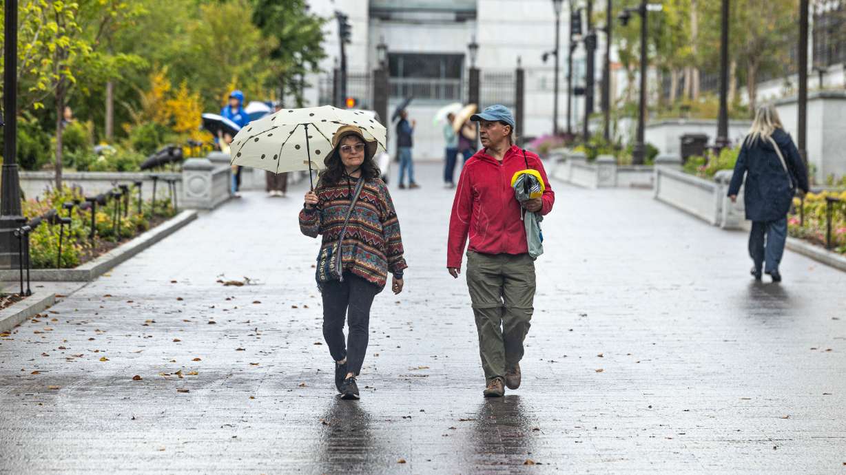 A pair walks through Temple Square on a rainy day in Salt Lake City on Sept. 28. Flood watches have been issued for central and southern Utah ahead of wet weather in the coming days, while the Wasatch Front will also get in on the action later in the week.