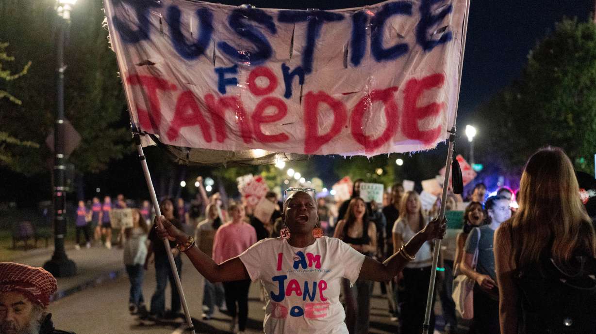A group marches toward the White House during a protest against sexual violence in Washington, on Oct. 8. A woman who accused seven Cornell University students of raping her said the president's response made her feel "disbelieved."