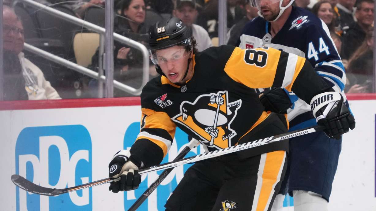 Pittsburgh Penguins' Ben Kindel (81) is defended by Winnipeg Jets' Josh Morrissey (44) during the second period of an NHL hockey game in Pittsburgh, Monday, Oct. 5, 2026.