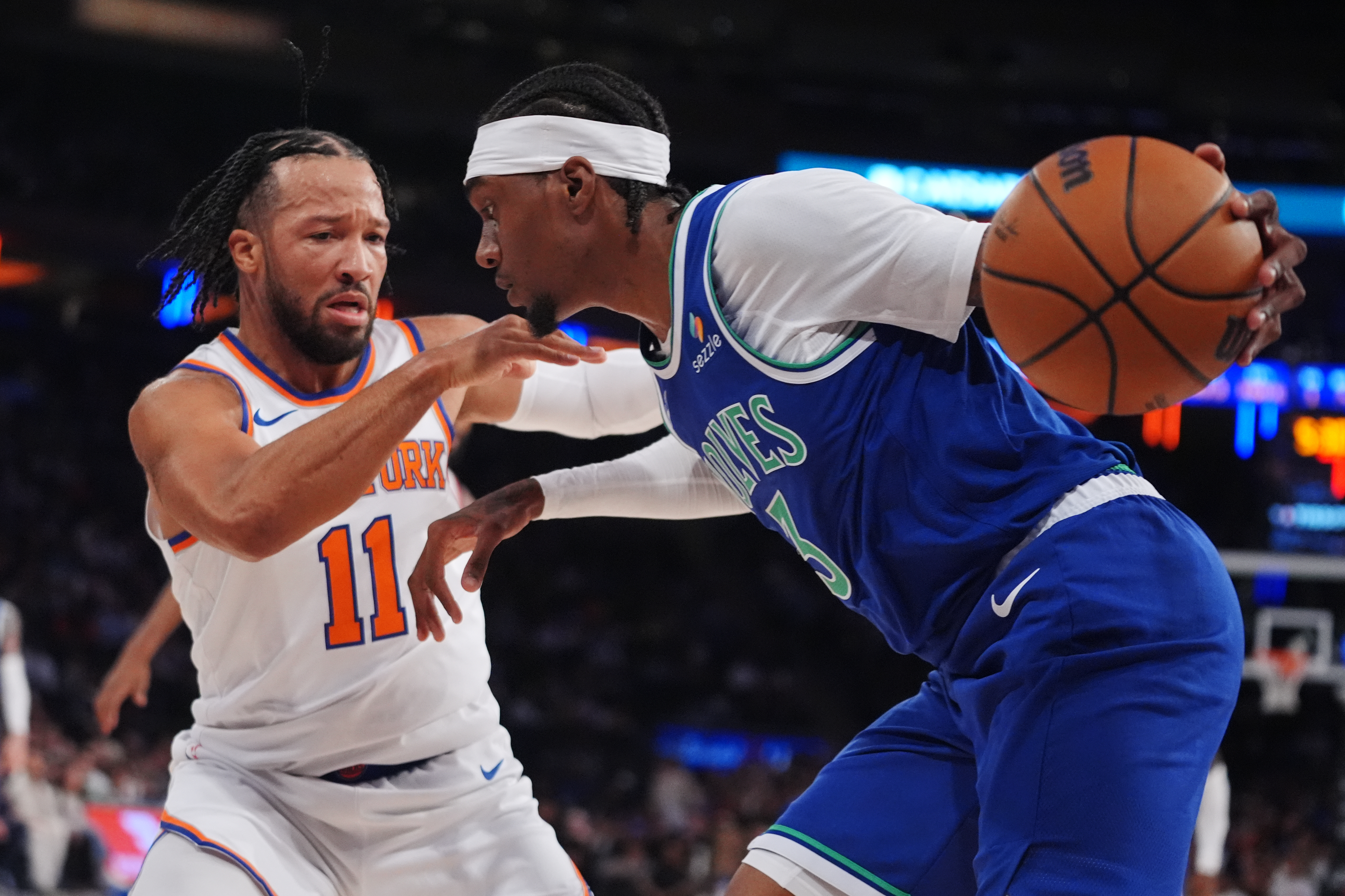 New York Knicks' Jalen Brunson (11) defends Minnesota Timberwolves' Jaden McDaniels (3) during the first half of a preseason NBA basketball game Monday, Oct. 12, 2026, in New York. 