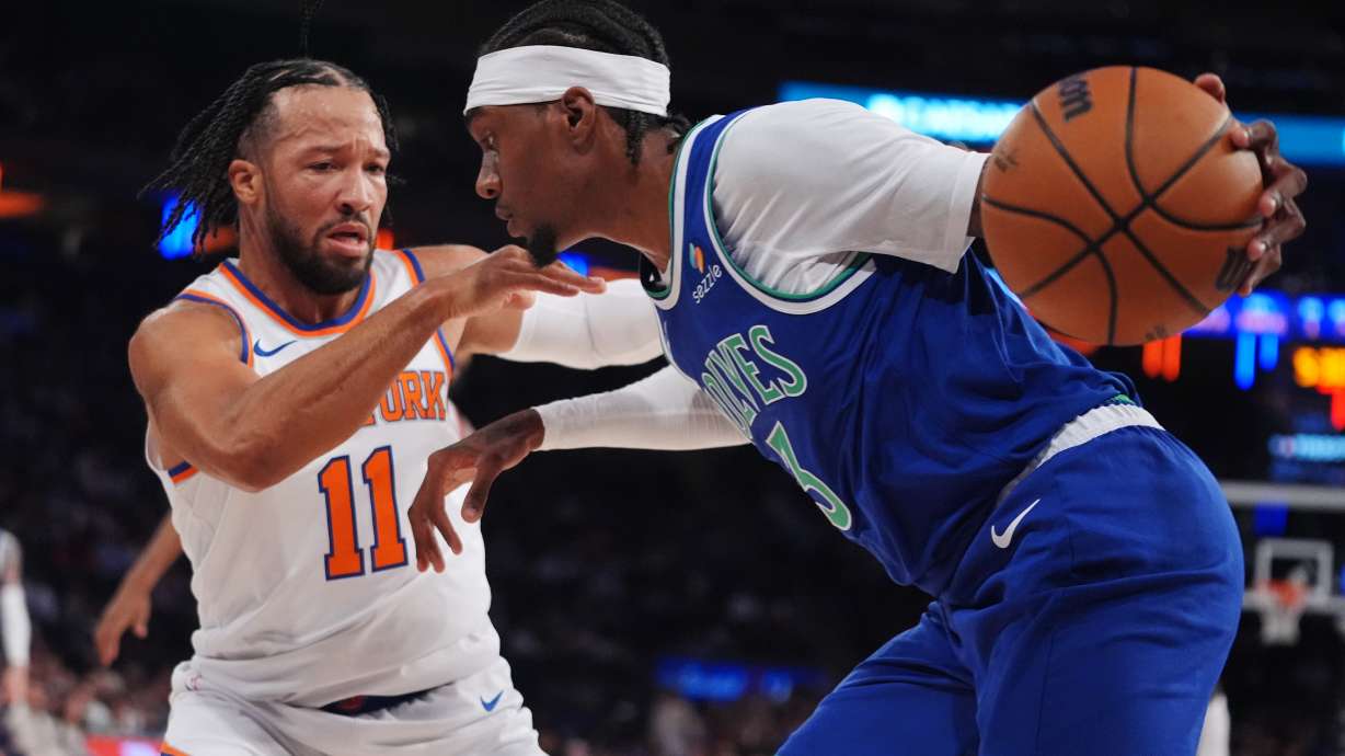 New York Knicks' Jalen Brunson (11) defends Minnesota Timberwolves' Jaden McDaniels (3) during the first half of a preseason NBA basketball game Monday, Oct. 12, 2026, in New York.
