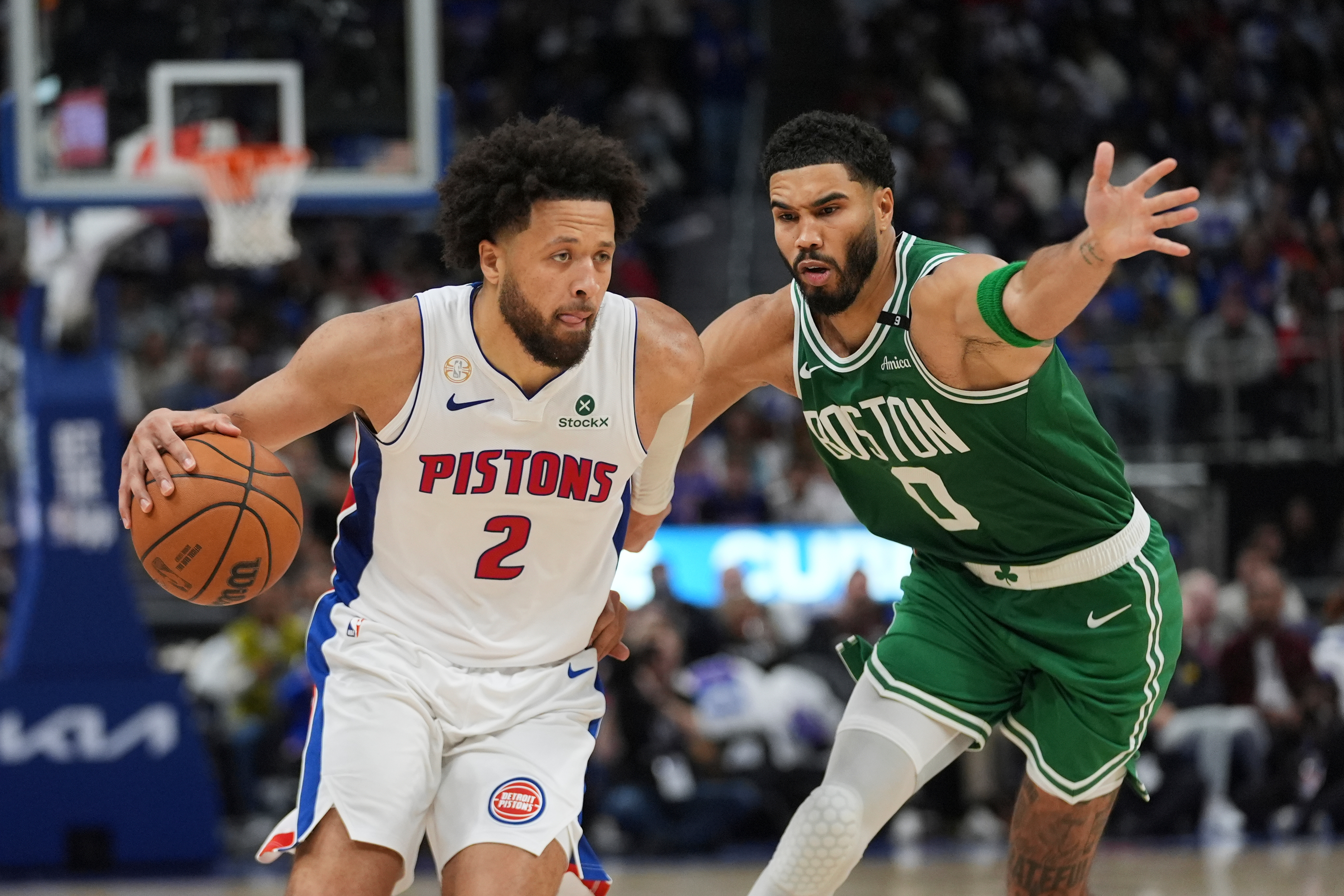 Detroit Pistons guard Cade Cunningham (2) drives on Boston Celtics forward Jayson Tatum (0) in the second half of an NBA basketball game in Detroit, Tuesday, Oct. 20, 2026. 