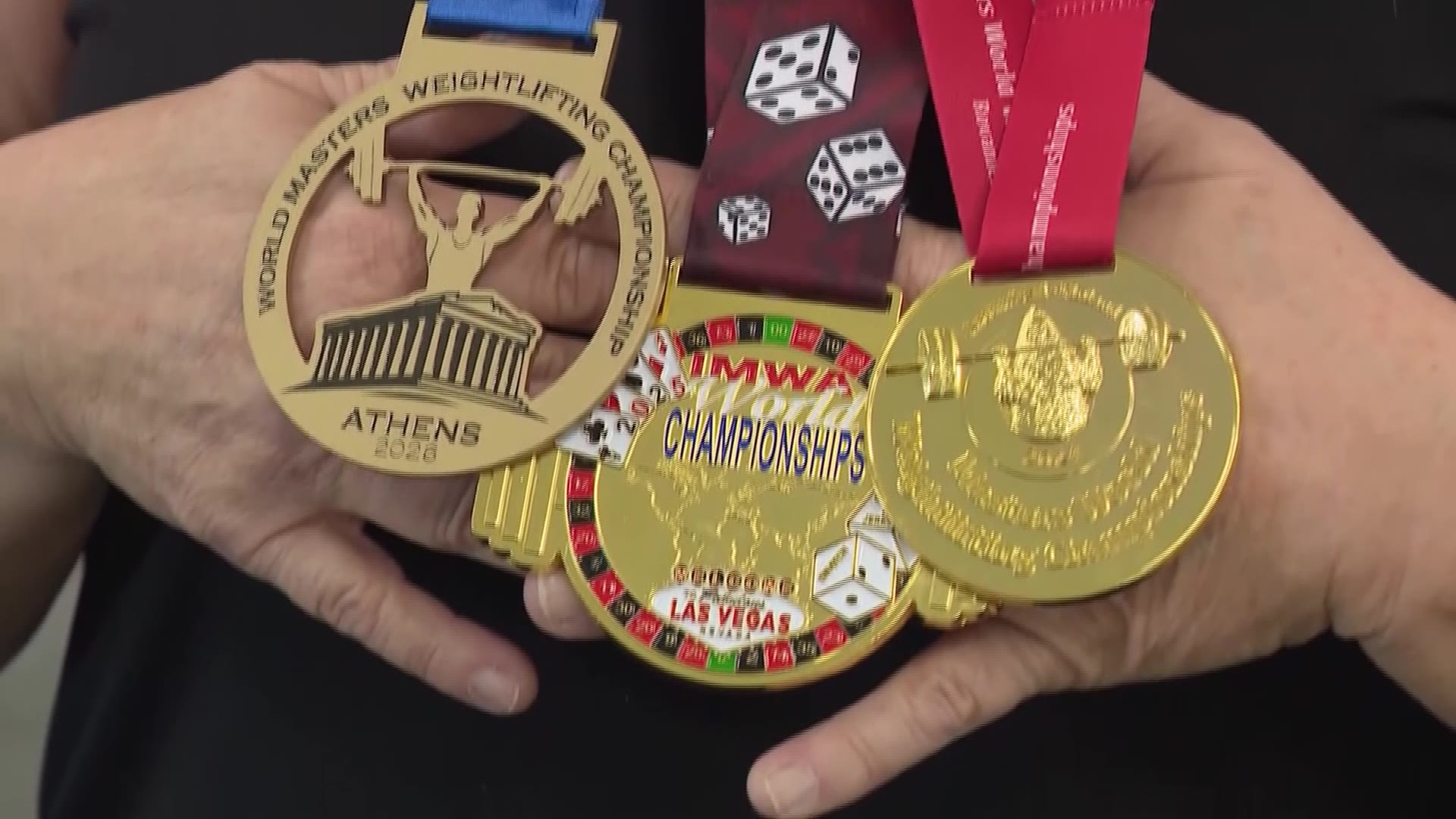 Michelle Galloway displays her weightlifting medals.