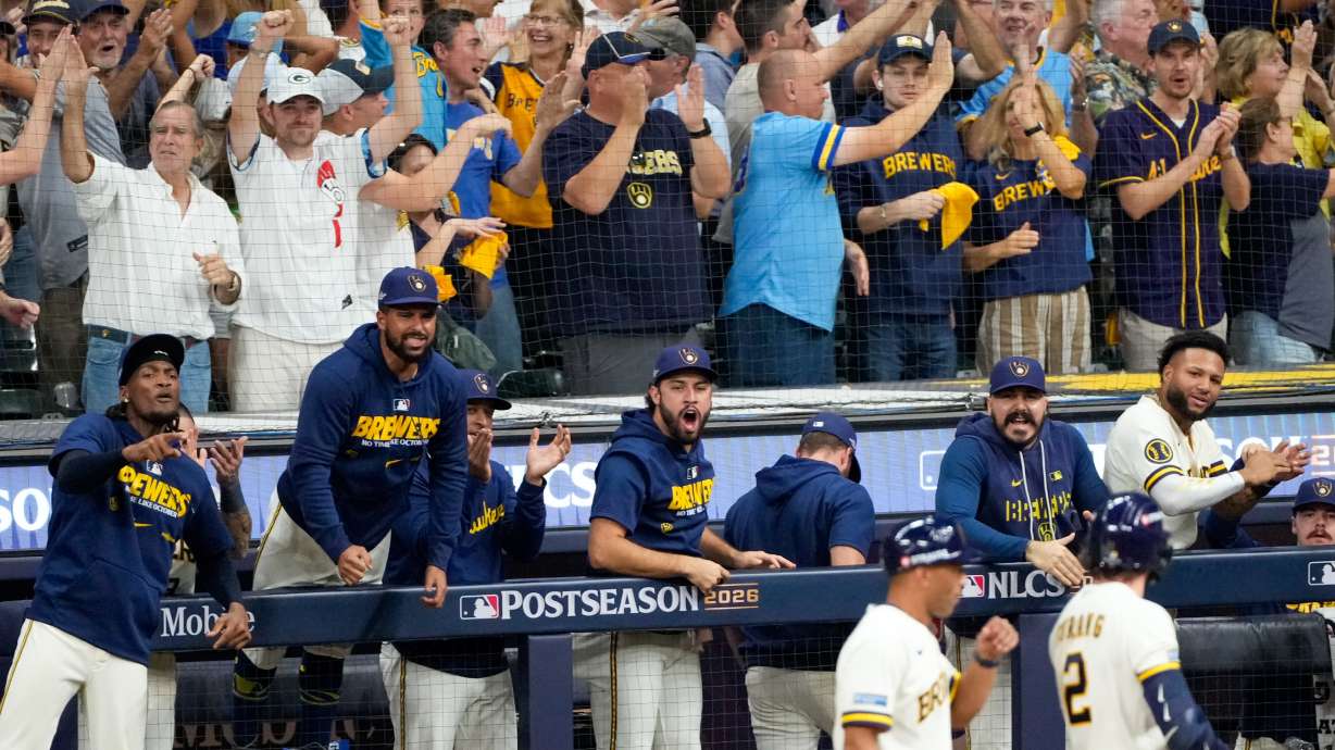 Milwaukee Brewers players and fans cheer during the eighth inning of Game 2 of baseball's National League Championship Series between the Milwaukee Brewers and the Los Angeles Dodgers, Monday, Oct. 12, 2026, in Milwaukee.