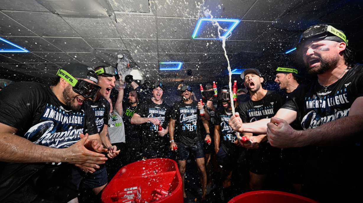 The Tampa Bay Rays celebrate their win in the locker room against the Cleveland Guardians in Game 6 of an American League Championship Series baseball game in St. Petersburg, Fla. Monday, Oct. 19, 2026.