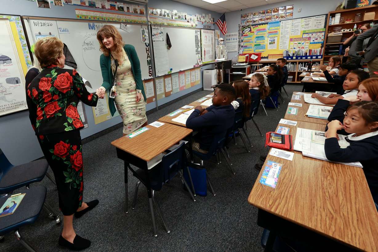 Secretary of Education Linda McMahon shakes hands with third grade teacher Britaini Delbo as McMahon visits American Preparatory Academy in West Valley City on Tuesday. McMahon said the Trump administration is trying to foster a sense of unity among all 50 states.