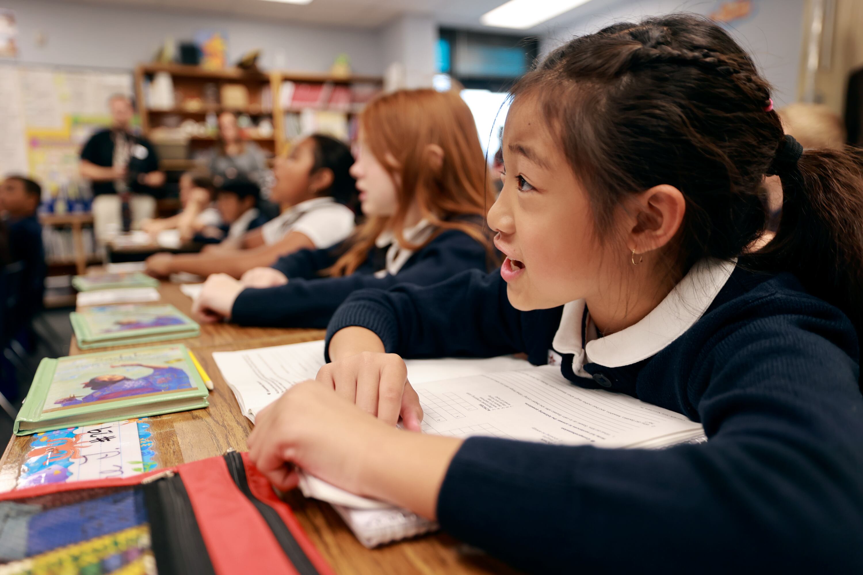 Addyzen Amata reads with her classmates in a learning based direct instruction reading achievement group at American Preparatory Academy in West Valley City on Tuesday. The school is the most diverse in the state of Utah.