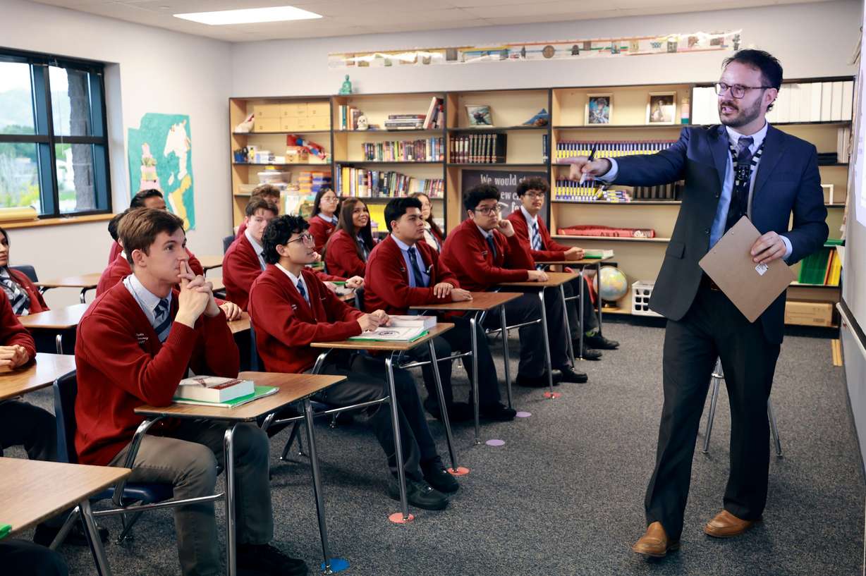 James Thomas teaches 12th grade Advanced Placement government at American Preparatory Academy in West Valley City on Tuesday. Secretary of Education Linda McMahon, as part of her visit to the school, sat in on the class.