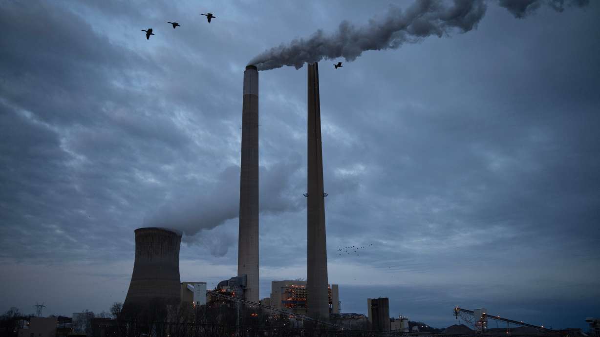 The coal-fired Mountaineer Power Plant, near New Haven, W.Va., operates across the Ohio River from the Lock 24 RV Park and Campground in Racine, Ohio, March 13. The United Nations projected on Wednesday that the world will still warm by another 2.2 degrees Fahrenheit.