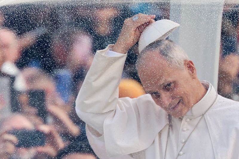 Pope Leo looks on from his popemobile as he arrives to hold his first weekly general audience in St. Peter's Square since cancer surgery, at the Vatican, on Wednesday.