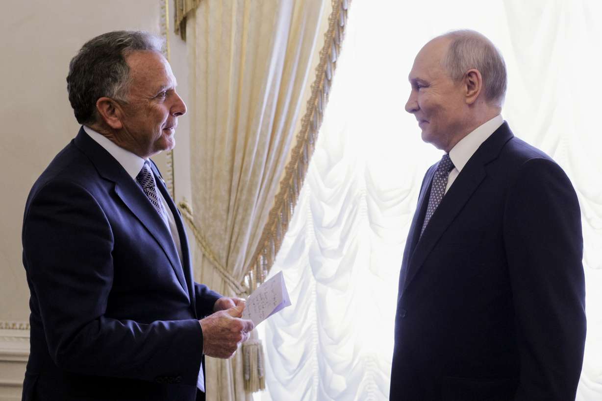 President Donald Trump's special envoy Steve Witkoff holds a paper while speaking to Russian President Vladimir Putin at the Konstantin Palace in Strelnya, outside St. Petersburg, Russia, on Wednesday. Trump's son-in-law, Jared Kushner, joined the talks virtually.