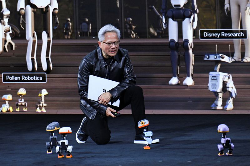 NVIDIA CEO Jensen Huang speaks to Microducks, 25 cm tall biped robots, during his keynote at the NVIDIA GTC conference, focused on advances in AI and computing shaping industries, in Berlin, Germany, October 21, 2026.