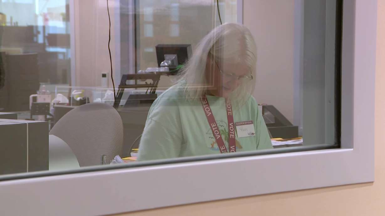 An election worker processes ballots at the Davis County Clerk's Office in Farmington, Tuesday. Voters can now watch ballots being processed through large viewing windows installed at the county clerk's office.