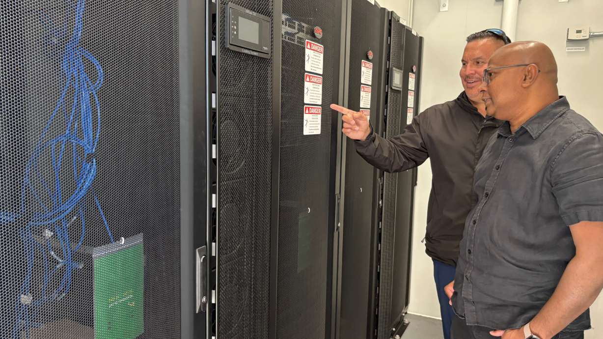 Wiikwemkoong's Chief Technology Officer Michael McCormick, right, and a worker inspect the community's data center in Wiikwemkoong, Ontario, Canada, July 22. For thousands of years, Indigenous peoples have passed down their traditions and culture through oral storytelling. Now, a Canadian Indigenous community is using a data center to help preserve its heritage.
