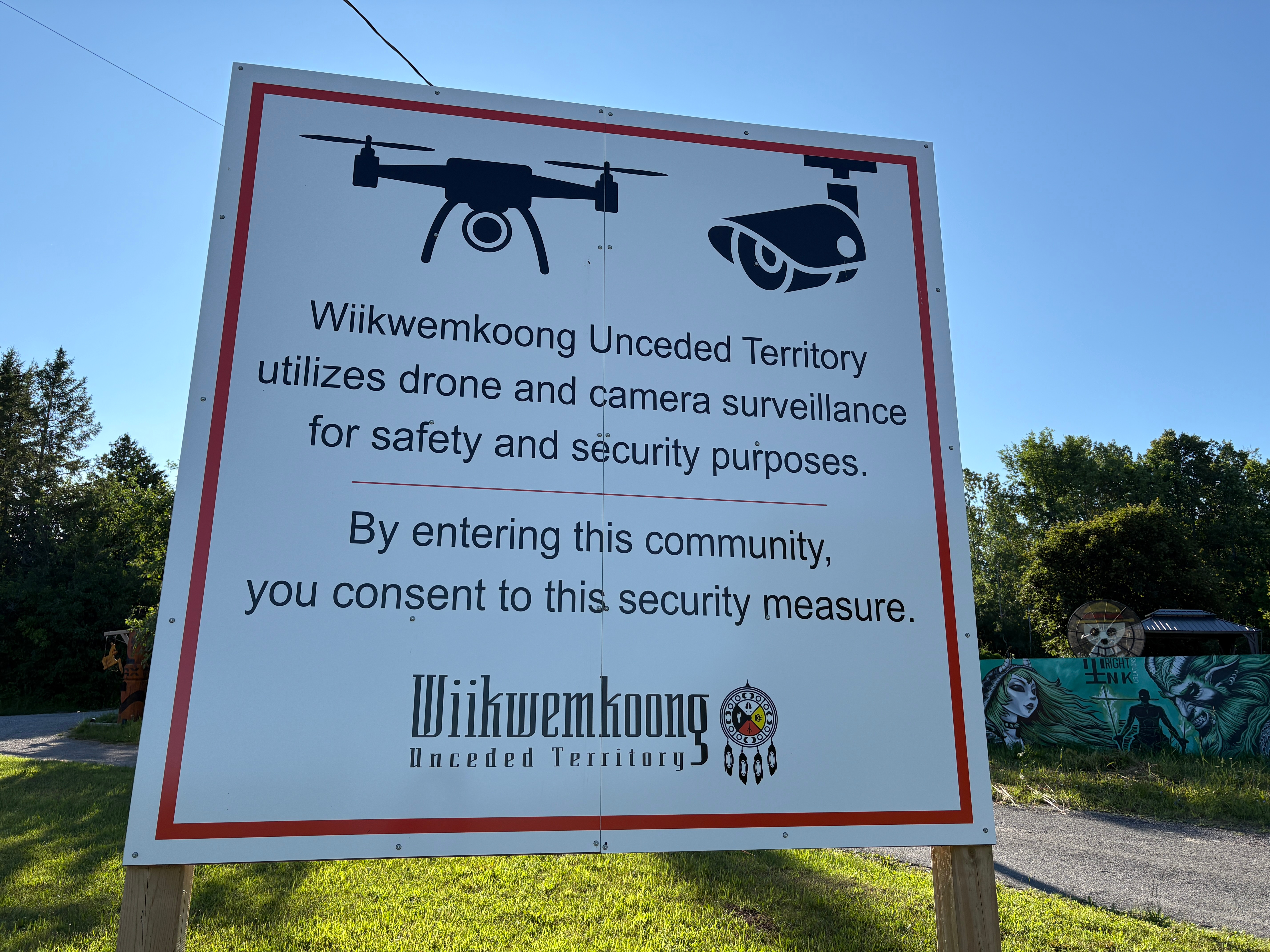 A sign warns visitors to the First Nations community of Wiikwemkoong that they could be monitored in Wiikwemkoong, Ontario, Canada, July 22.