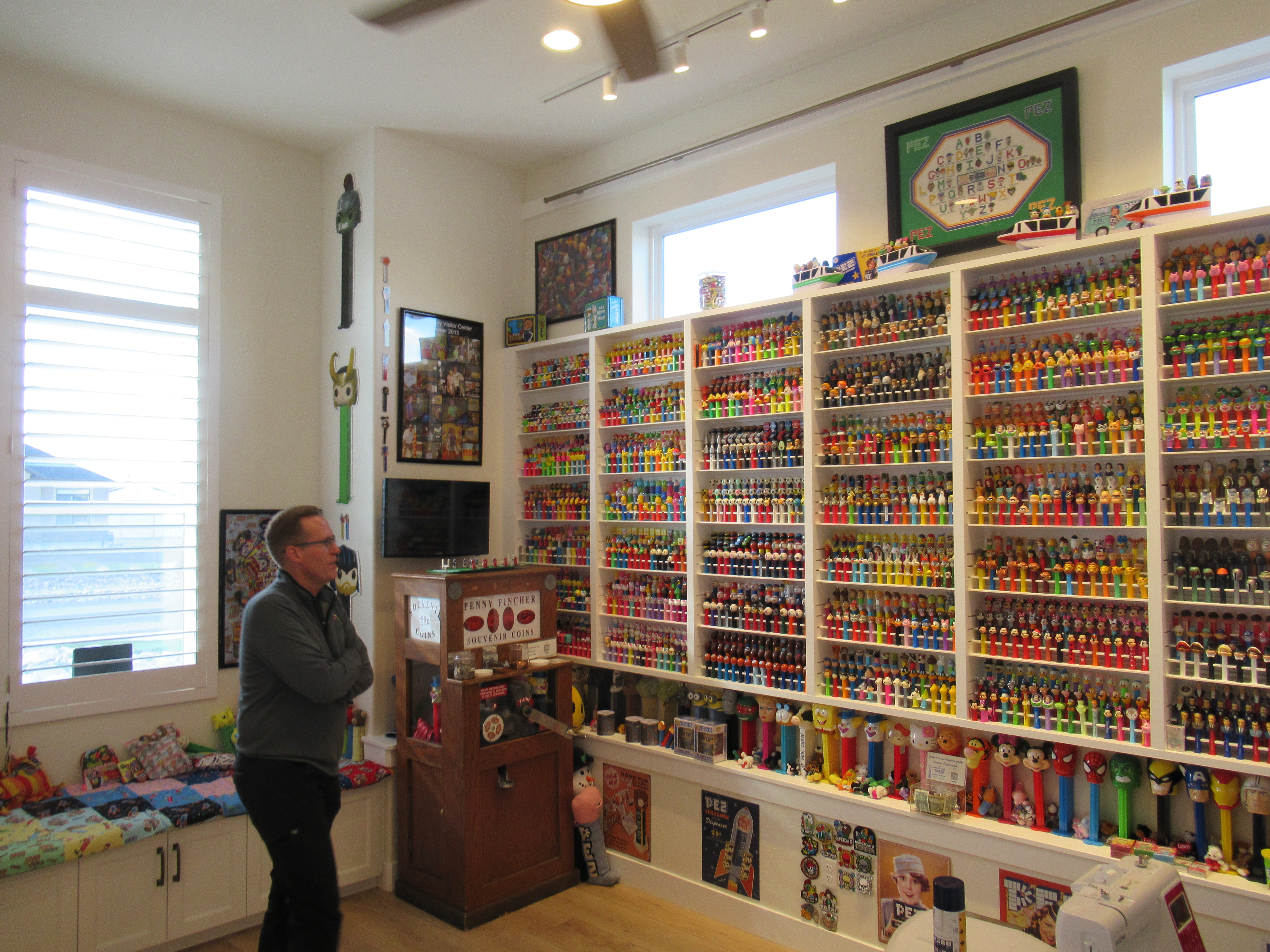 Brent Beezer, owner of the International Pez Museum of Erda, stands in front of one wall of his collection on Tuesday.