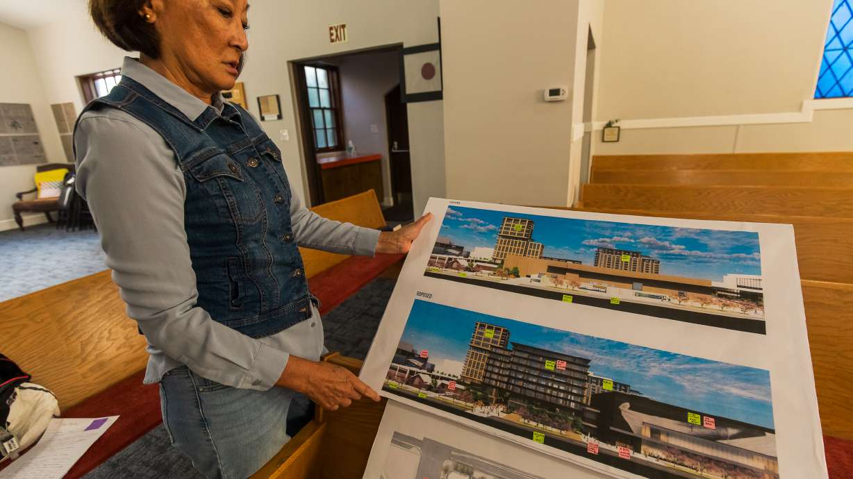Lynne Ward, an elder at the Japanese Church of Christ, holds a printout of Smith Entertainment Group's downtown plans that would neighbor the church in downtown Salt Lake City on Wednesday. The church is concerned about construction impacts and other elements of the design released last week.