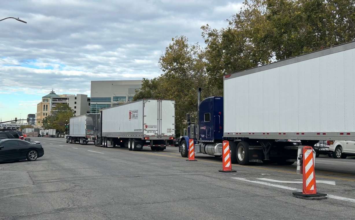 Semitrucks with gear for a Delta Center line 100 South outside of the Japanese Church of Christ on Tuesday. Church leaders are concerned that a new venue proposed in the area will add truck traffic on 100 South/Japantown Street.