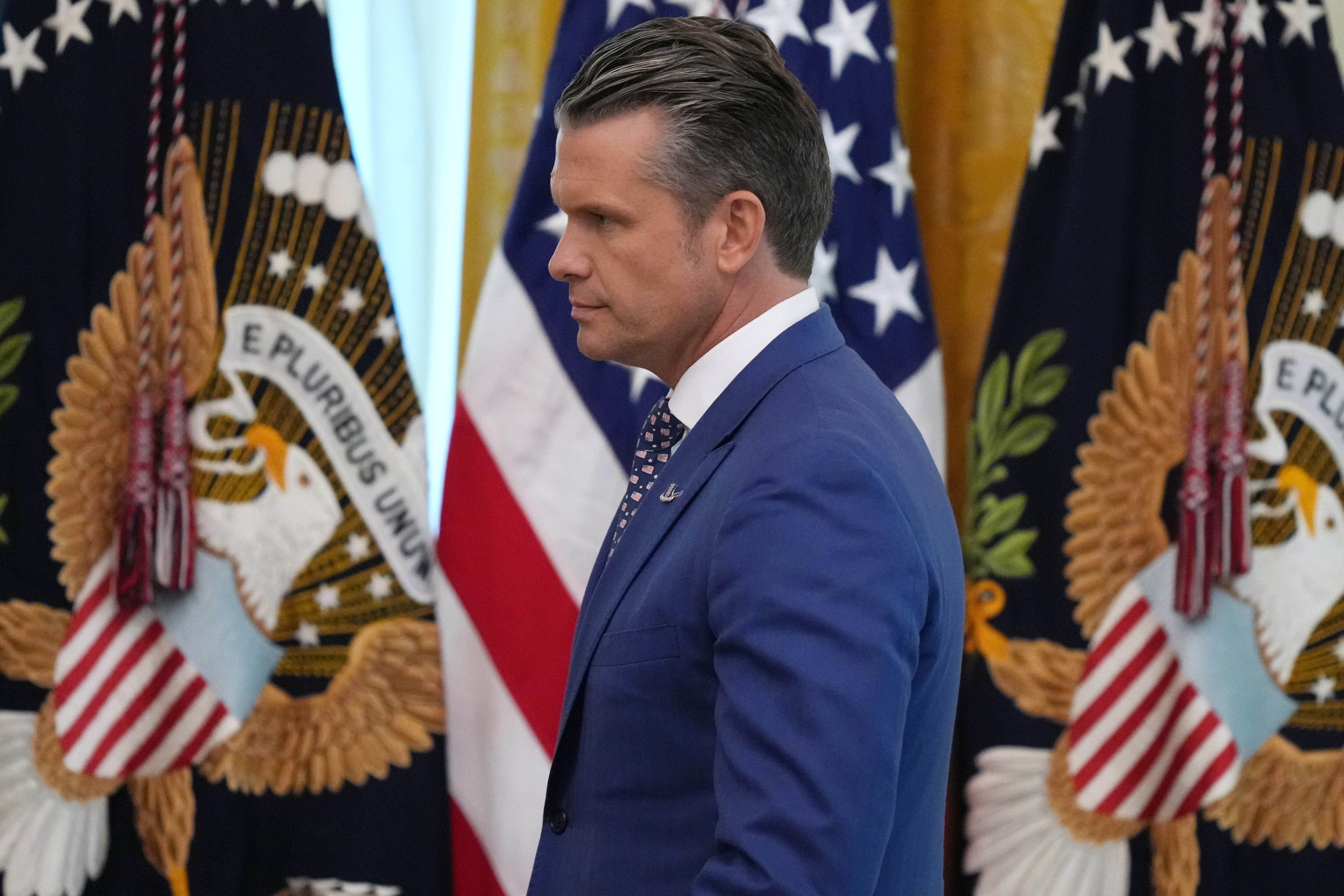 Defense Secretary Pete Hegseth arrives before President Donald Trump speaks at a roundtable event in the East Room of the White House, Wednesday, in Washington. Hegseth ordered 30 colleges to cut ties with "foreign entities of concern."