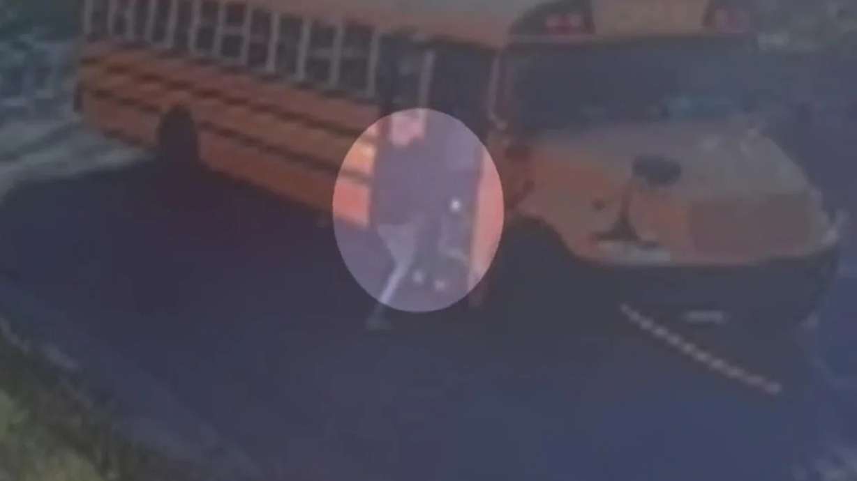 Surveillance footage shows Ebro Ahmed rush into the runaway school bus in St. Paul, Minnesota, on Oct. 19, 2026.