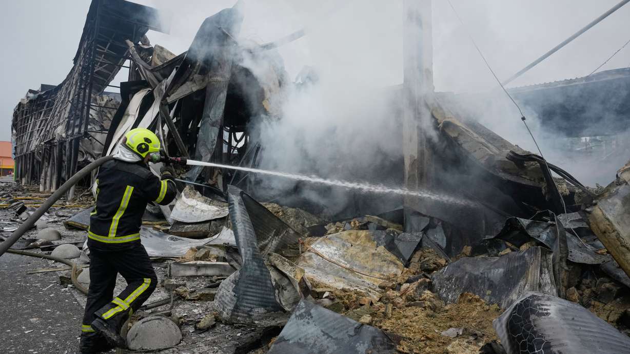 Firefighters try to extinguish a fire after a Russian missile attack in central Kyiv, Ukraine, Thursday. Russia launched a nighttime barrage at Kyiv while intercepting over 800 Ukrainian drones, furthering dampening hopes of peace talks.