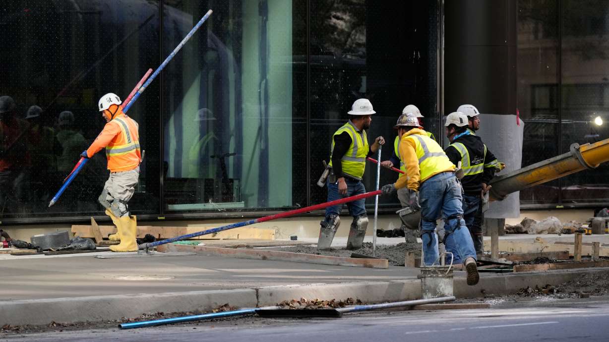 Construction workers work in Chicago, Tuesday. Unemployment claims fell to 194,000 last week, the fewest in three months and another sign that layoffs remain low and most Americans enjoy extraordinary job security.