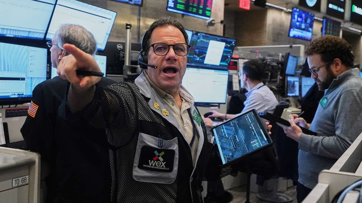 Options trader Anthony Spina works on the floor of the New York Stock Exchange, Jan. 7. AI stocks are tumbling and dragging stock markets down around the world, as oil prices are rising on renewed fears of a return to war in the Middle East.