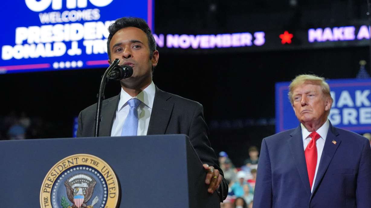 President Donald Trump listens as gubernatorial candidate Vivek Ramaswamy speaks at a campaign rally at the Covelli Centre, in Youngstown, Ohio on Oct. 12.