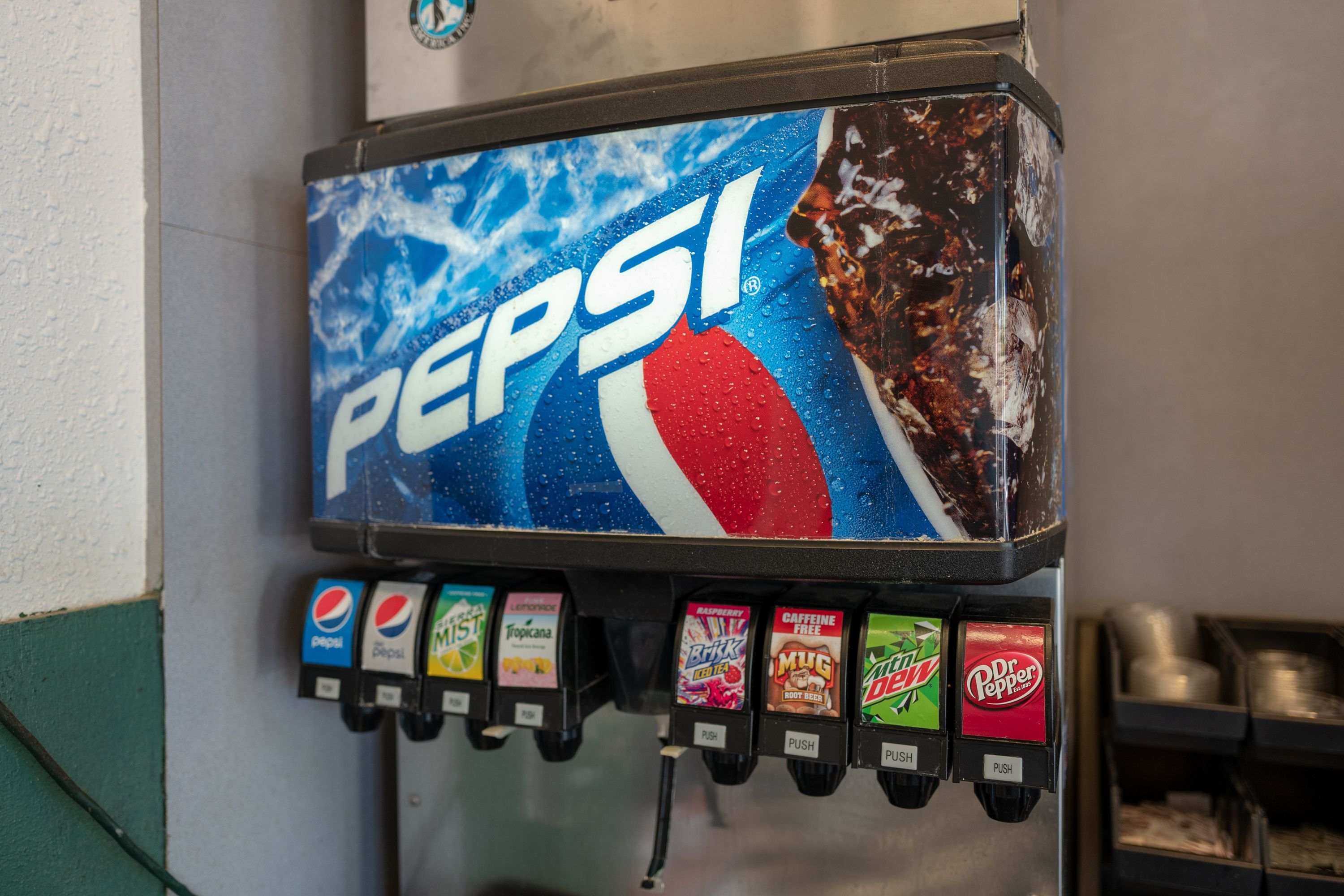 A soda fountain with PepsiCo products.