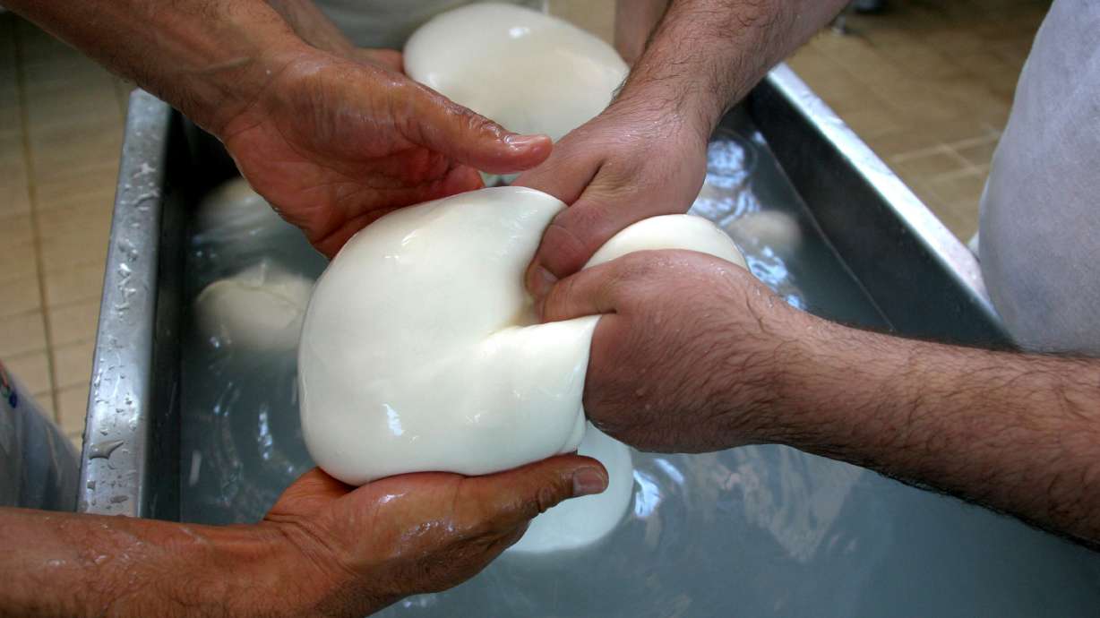 Buffalo mozzarella cheese is prepared at a dairy in Caserta, near Naples, Italy in 2006. A truckers' protest in southern Italy has halted the production of the famous cheese.