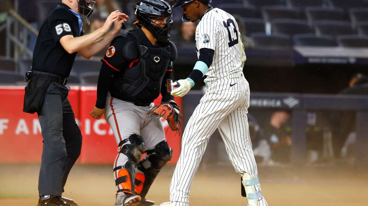 Home plate umpire Nic Lentz, left, calls time after the wind blew up dust during an at-bat of New York Yankees' Jazz Chisholm Jr., right, during the seventh inning of the second baseball game of a doubleheader against the Baltimore Orioles, Friday, Sept. 25, 2026, in New York.