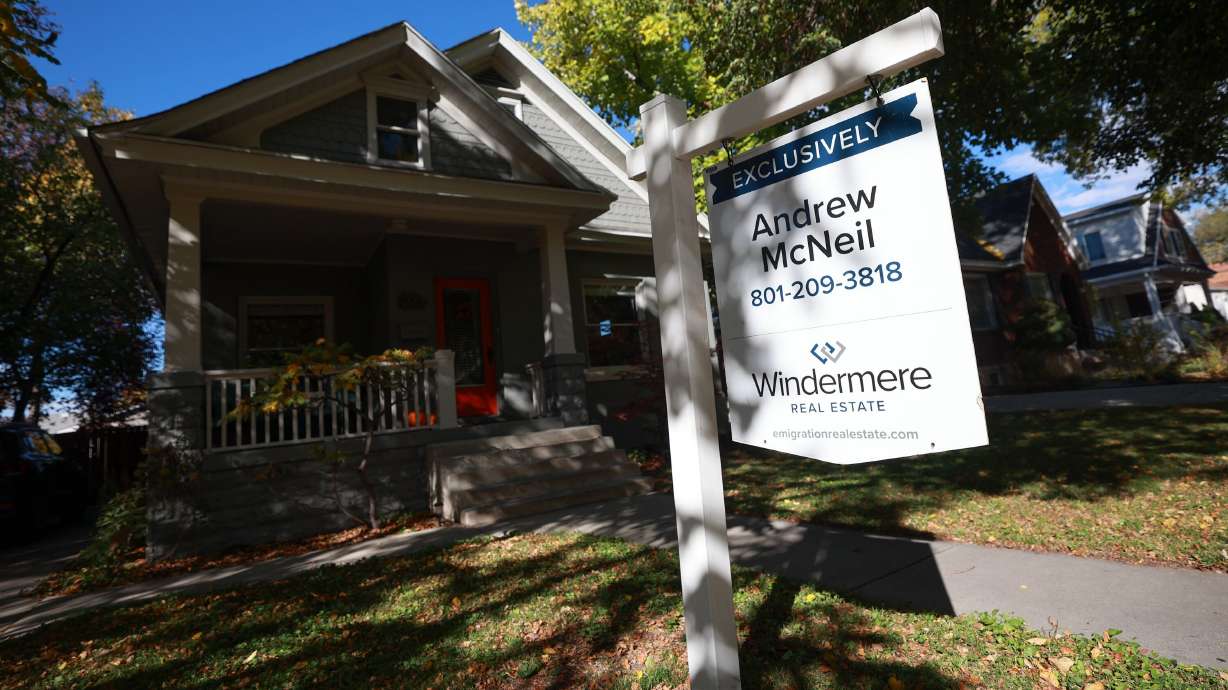 A for-sale sign outside a house in Salt Lake City on Wednesday. Mortgage rates slid slightly downward Thursday.