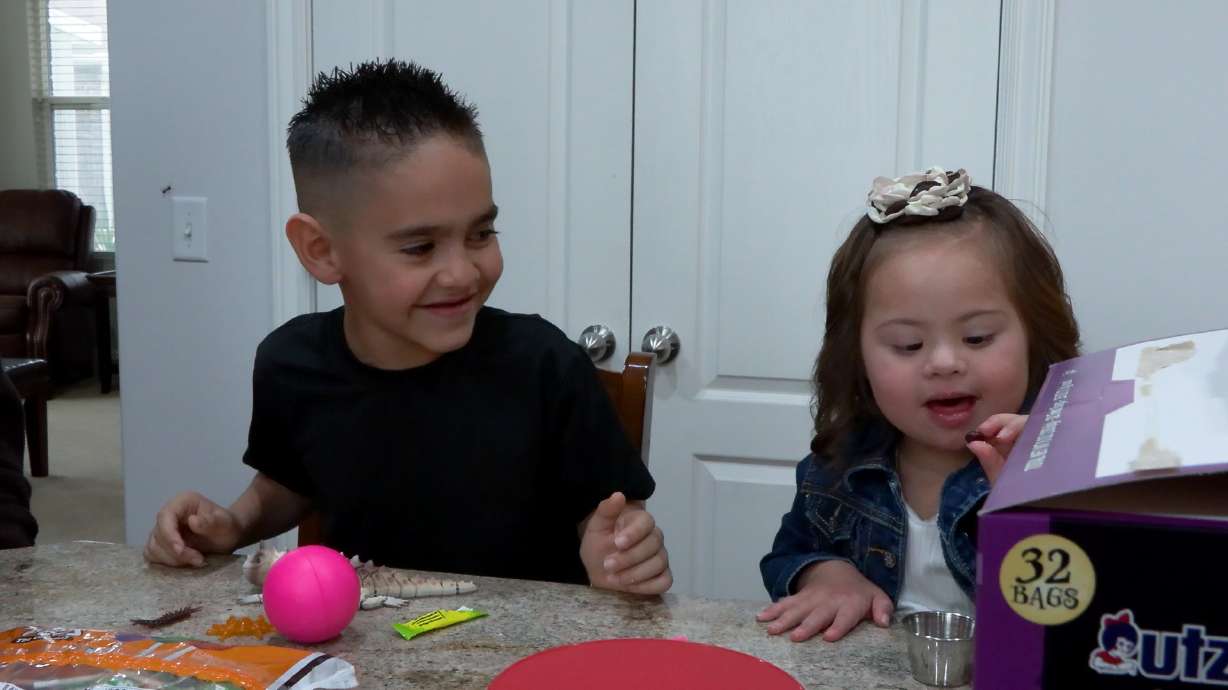 Easton Bennett and his younger sister sort through treats in Syracuse.