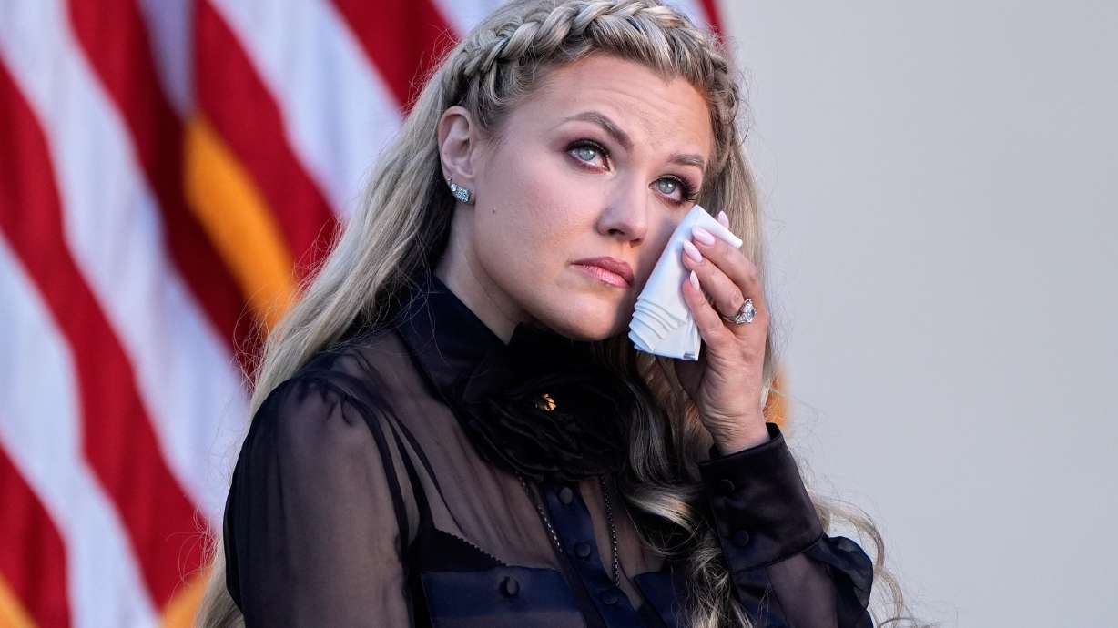 Erika Kirk wipes her eyes as a military aide reads the citation before President Donald Trump posthumously awards the Presidential Medal of Freedom to Charlie Kirk in the Rose Garden of the White House, Oct. 14, 2025, in Washington.