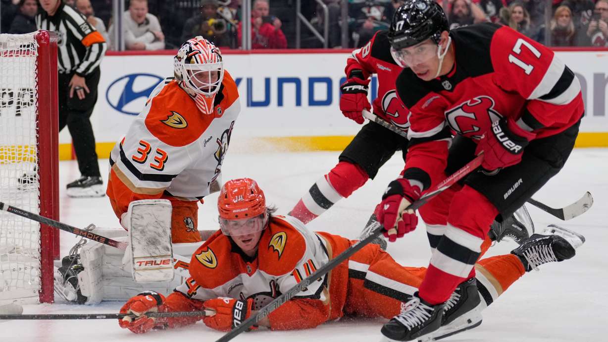 Anaheim Ducks goaltender Ville Husso, left, defends the net during the second period of an NHL hockey game against the New Jersey Devils in Newark, N.J., Thursday, Oct. 22, 2026.