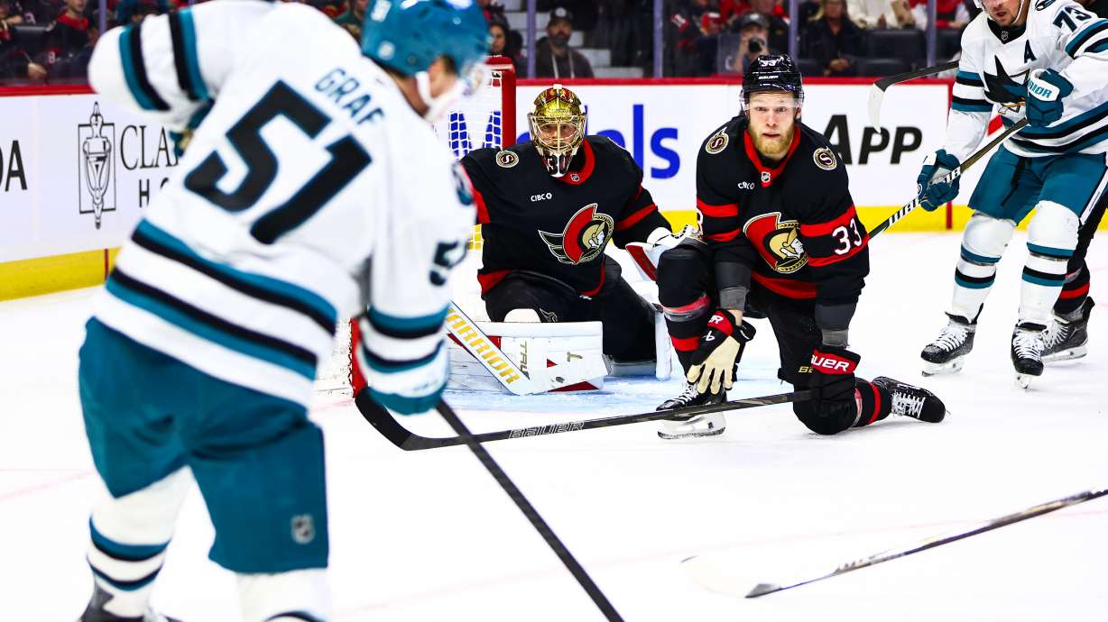 Ottawa Senators' Nikolas Matinpalo (33) looks to block a shot from San Jose Sharks' Collin Graf (51) during first period NHL action in Ottawa, on Thursday, Oct. 22, 2026.