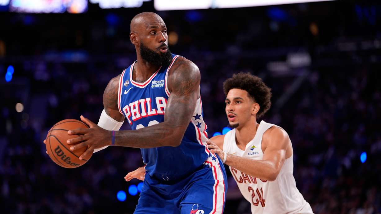 Philadelphia 76ers' LeBron James, left, tries to get past Cleveland Cavaliers' Tyrese Proctor during the first half of an NBA basketball game Thursday, Oct. 22, 2026, in Philadelphia.