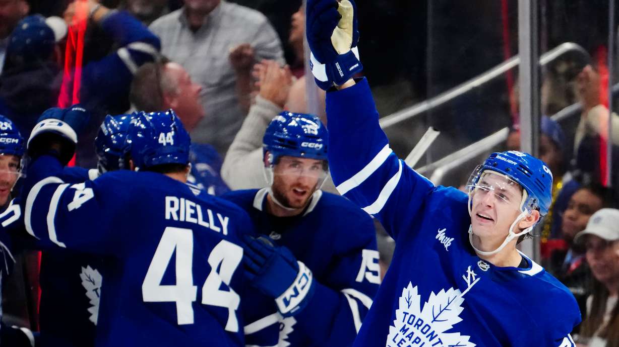 Toronto Maple Leafs' Troy Stecher, right, celebrates after his goal against the New York Rangers during the third period of an NHL hockey game in Toronto, Thursday, Oct. 22, 2026.