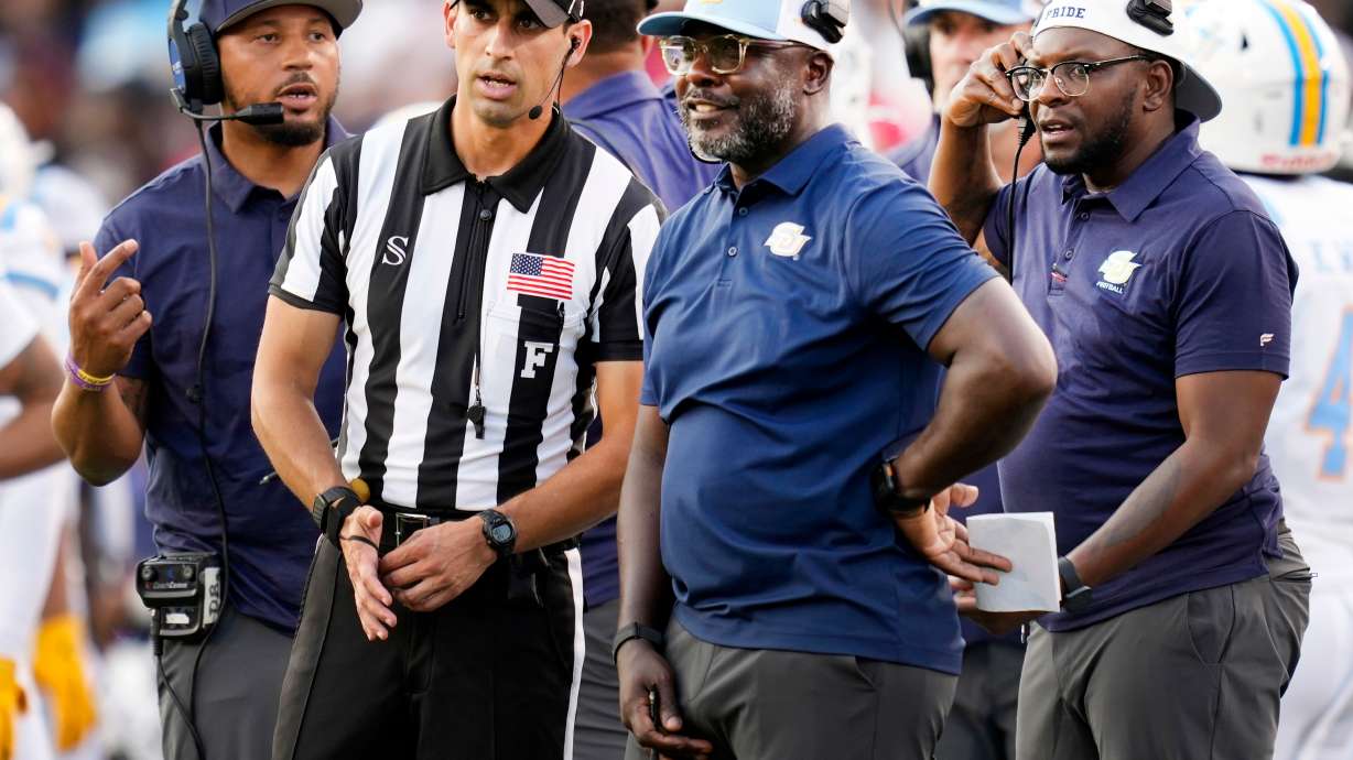 FILE - Southern head coach Marshall Faulk, center right, talks with an official during the first half of an NCAA college football game against Houston in Houston, Saturday, Sept. 12, 2026.
