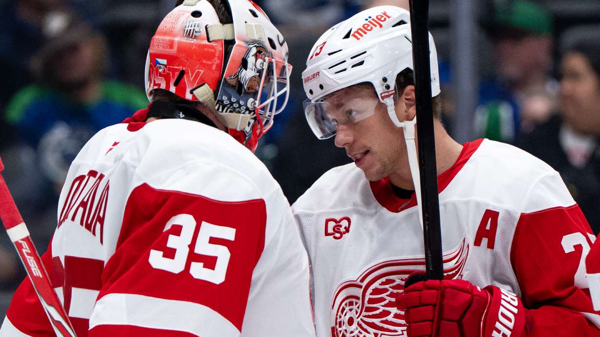Detroit Red Wings goaltender Michal Postava (35) and Lucas Raymond (23) celebrate after defeating the Vancouver Canucks in an NHL hockey game in Vancouver, British Columbia, Thursday, Oct. 22, 2026.