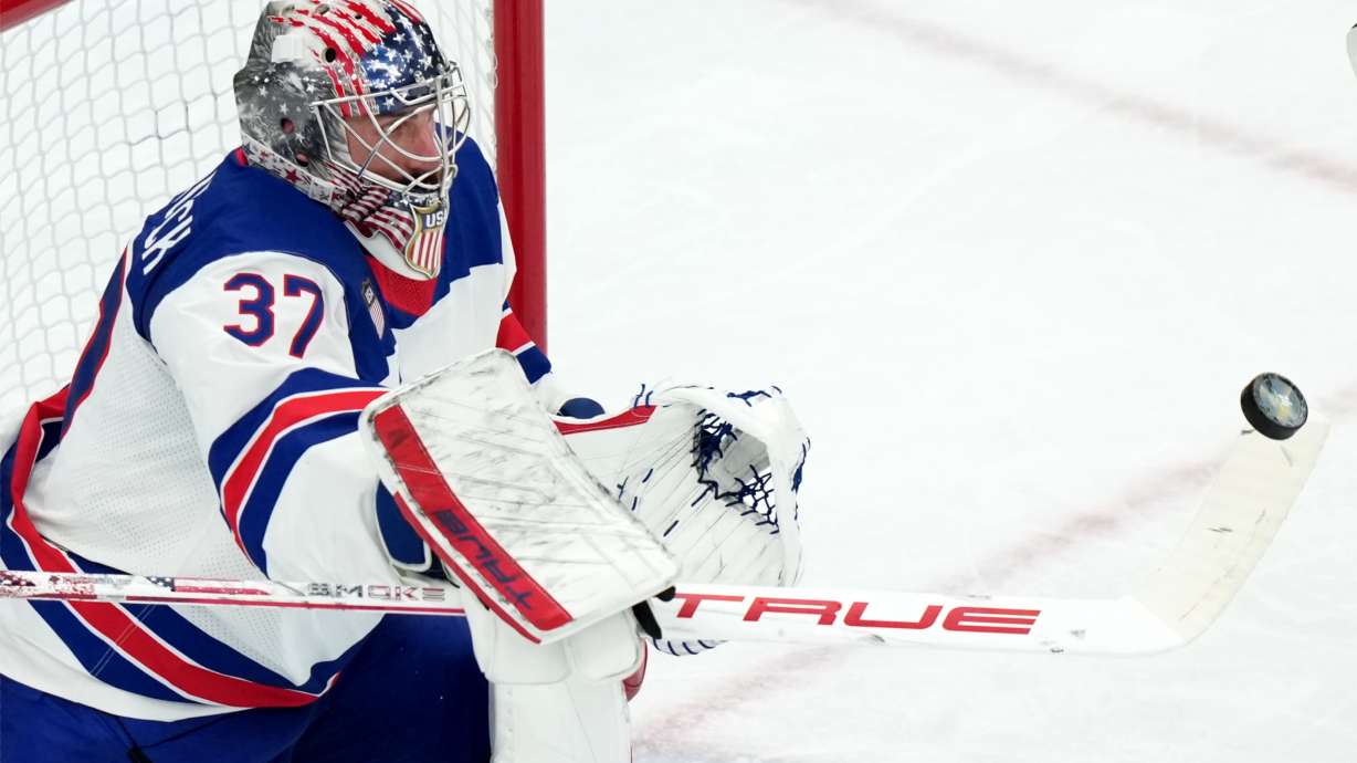 FILE - United States goalkeeper Connor Hellebuyck blocks a shot against Canada during the third period of the men's ice hockey gold medal game at the 2026 Winter Olympics in Milan, Italy, Sunday, Feb. 22, 2026.