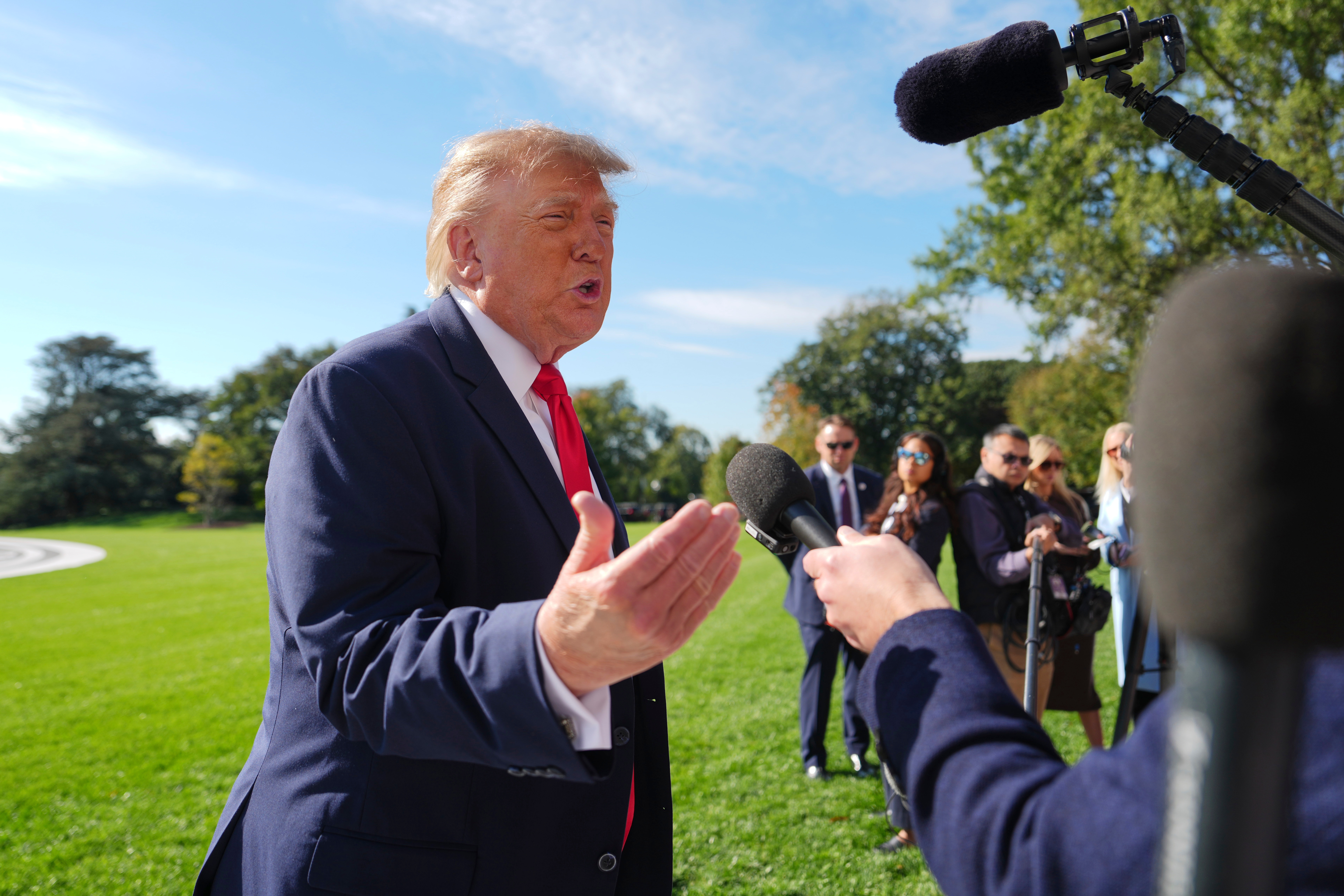 President Donald Trump speaks with reporters before boarding Marine One on the South Lawn of the White House, Friday, Oct. 23, 2026, in Washington.