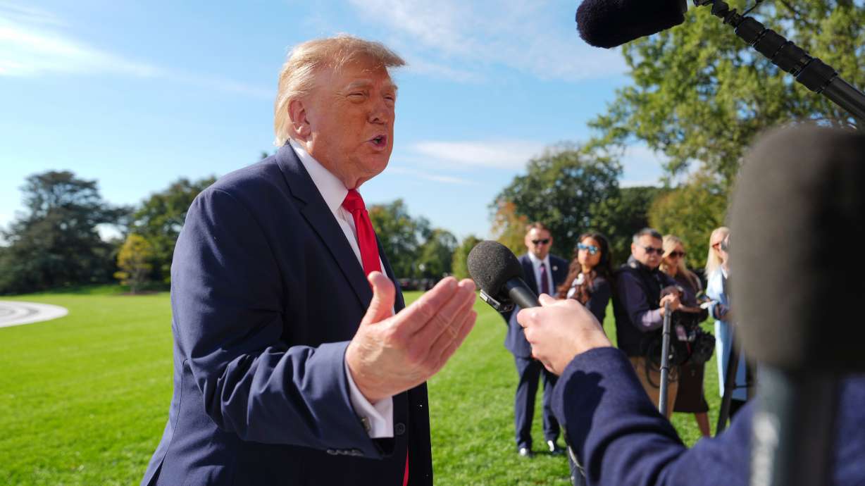 President Donald Trump speaks with reporters before boarding Marine One on the South Lawn of the White House, Friday, Oct. 23, 2026, in Washington.