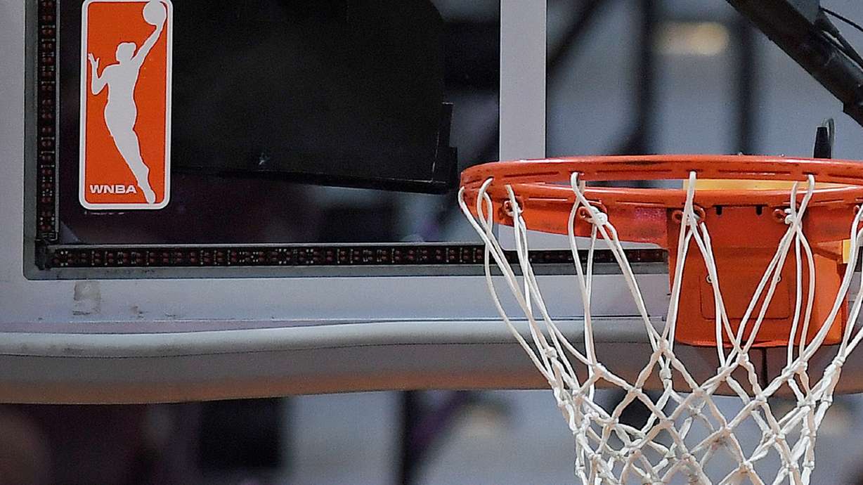 FILE - The WNBA logo is seen near a hoop before an WNBA basketball game at Mohegan Sun Arena, May 14, 2019, in Uncasville, Conn.